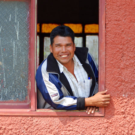 A man smiling in a window
