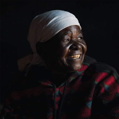 A smiling, dark-skinned woman